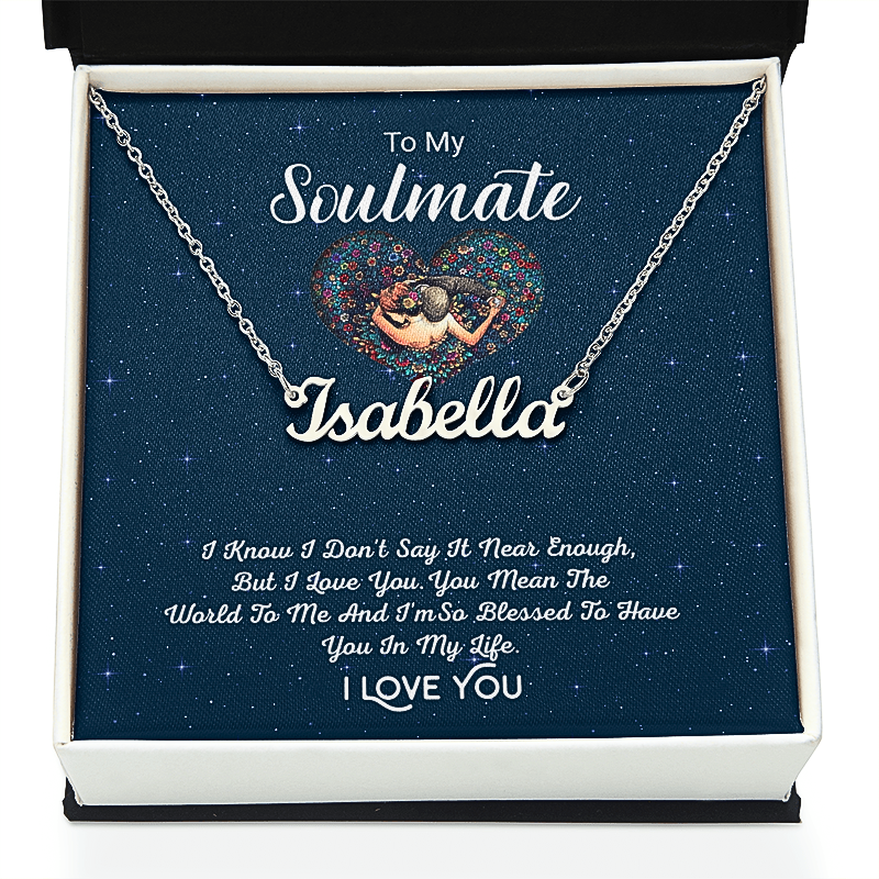 A silver nameplate necklace displayed inside a white gift box with a dark blue starry insert. The necklace has a custom nameplate reading 'Isabella' and is shown with the message 'To My Soulmate Isabella' and a romantic poem printed on the insert card.
