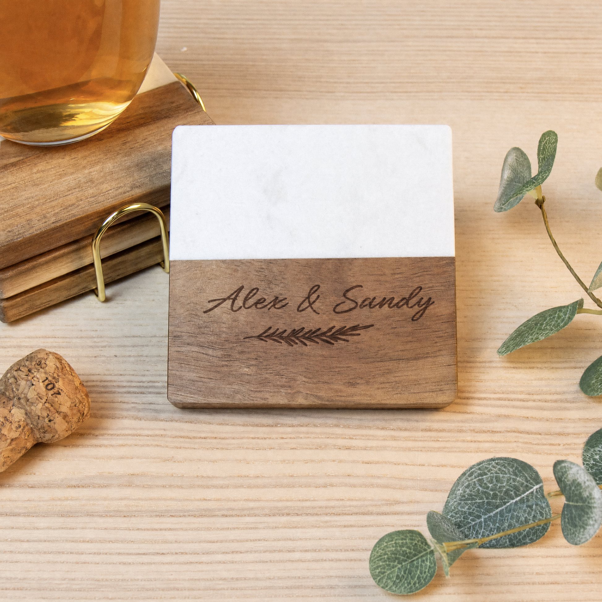 Personalized marble and walnut wood wine coaster engraved with "Alex & Sandy"